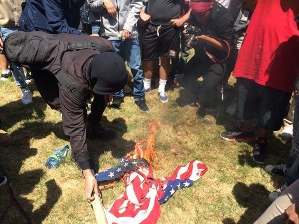 Trump protesters burn American flag Twitter AJPlus