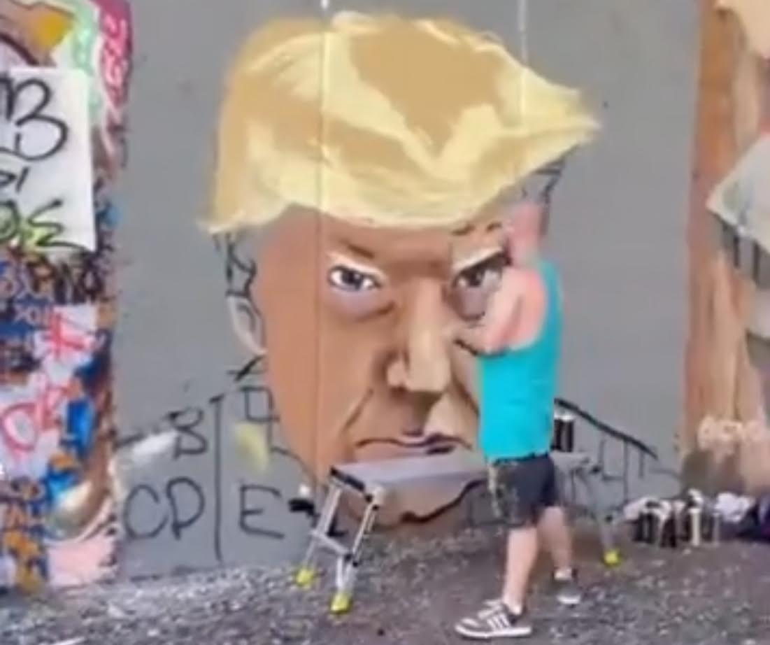 WATCH: Popular Atlanta Muralist Paints Giant Mural of Trump’s Mugshot
