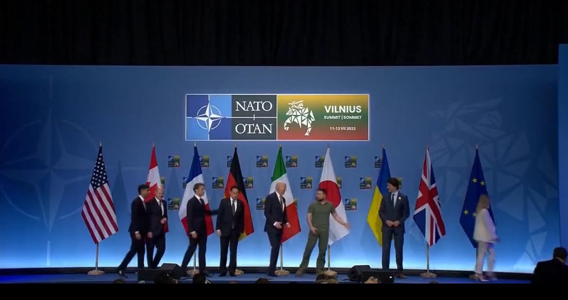 Zelensky Has to Tell Joe Biden to Follow Him After Taking Group Photo at NATO Summit (VIDEO)