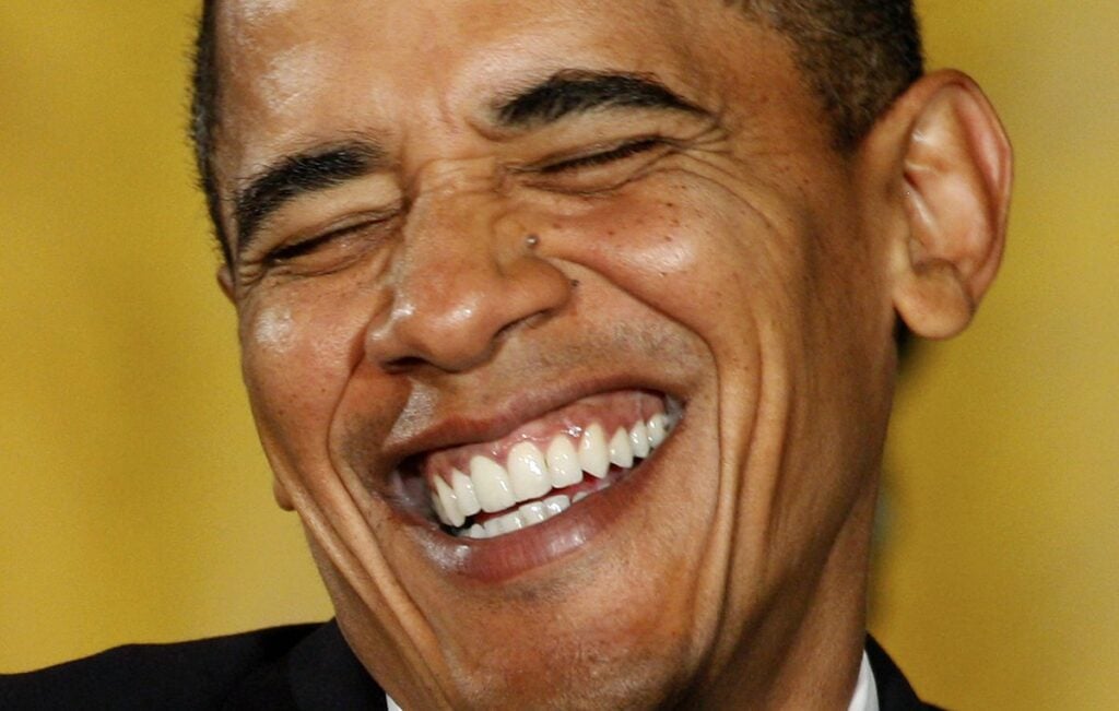 U.S. President Barack Obama smiles after making remarks on regulatory reform in the East Room at the White House in Washington