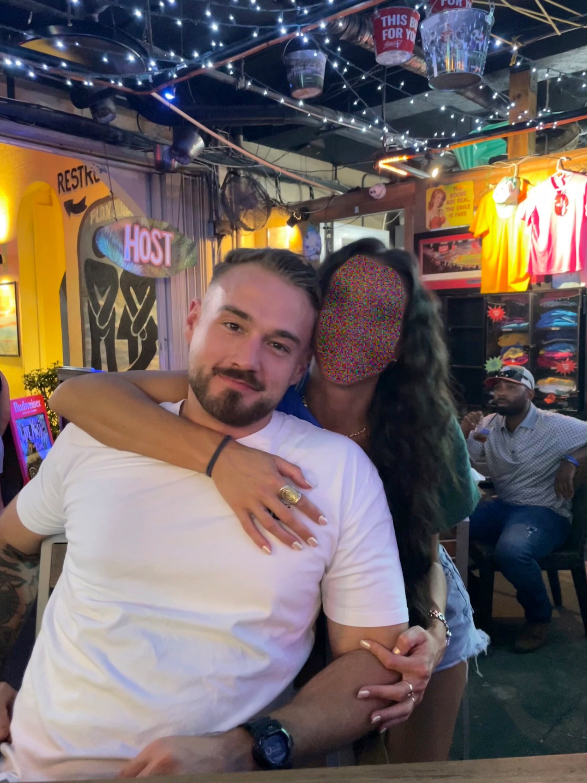 AJ Fisher and his fiancee (face blurred to protect her from retaliation) as they await his upcoming January 6th trial.