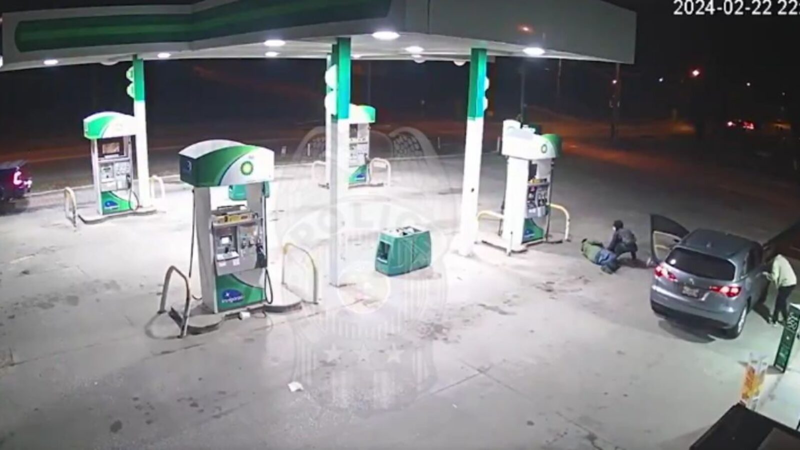 According to Kansas City police, surveillance video at a gas station last month shows a suspect going through the pockets of a man who was lying injured after being shot. The suspect was "looking for valuables,” police said.