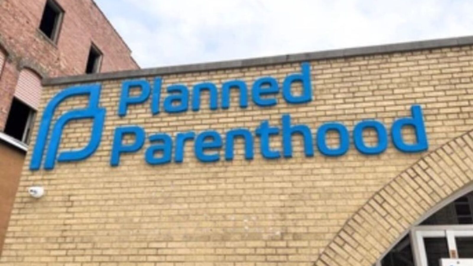 Planned Parenthood sign on a brick building, representing reproductive health services and community support.