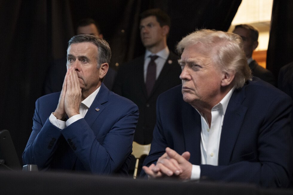 Donald Trump and an advisor display concern during a tense moment, with other officials in the background, highlighting a significant political event.