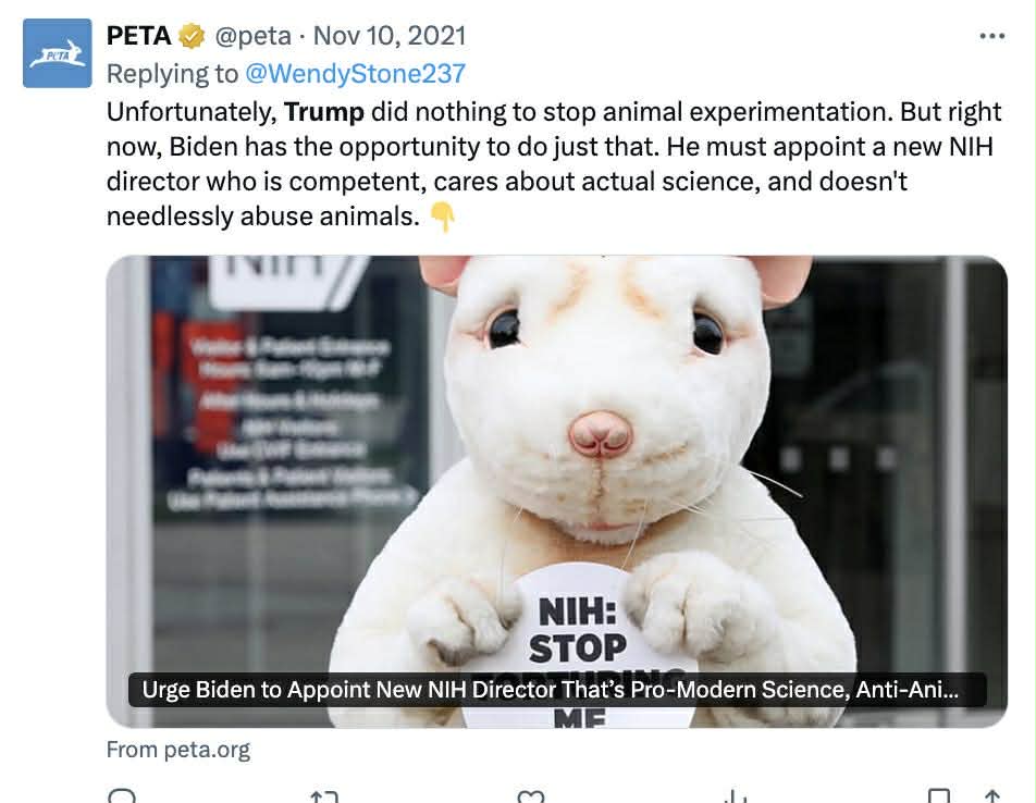 PETA campaign urging Biden to appoint a new NIH director focused on modern science and animal welfare, featuring a person in a rat costume holding a sign.