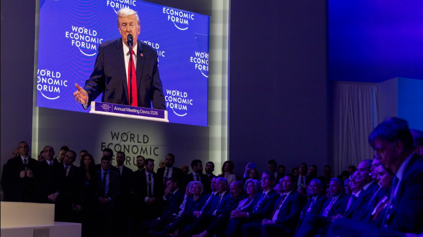 Donald Trump speaks at the World Economic Forum Annual Meeting in Davos 2026, with an audience of global leaders and officials listening attentively.