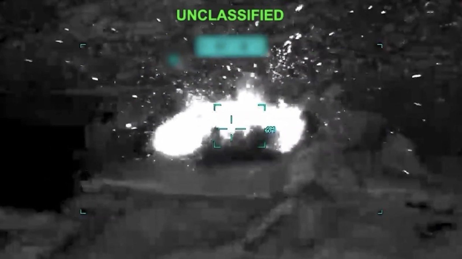 Night vision footage showing an explosion in a military operation, labeled as unclassified, with a soldier in the foreground.