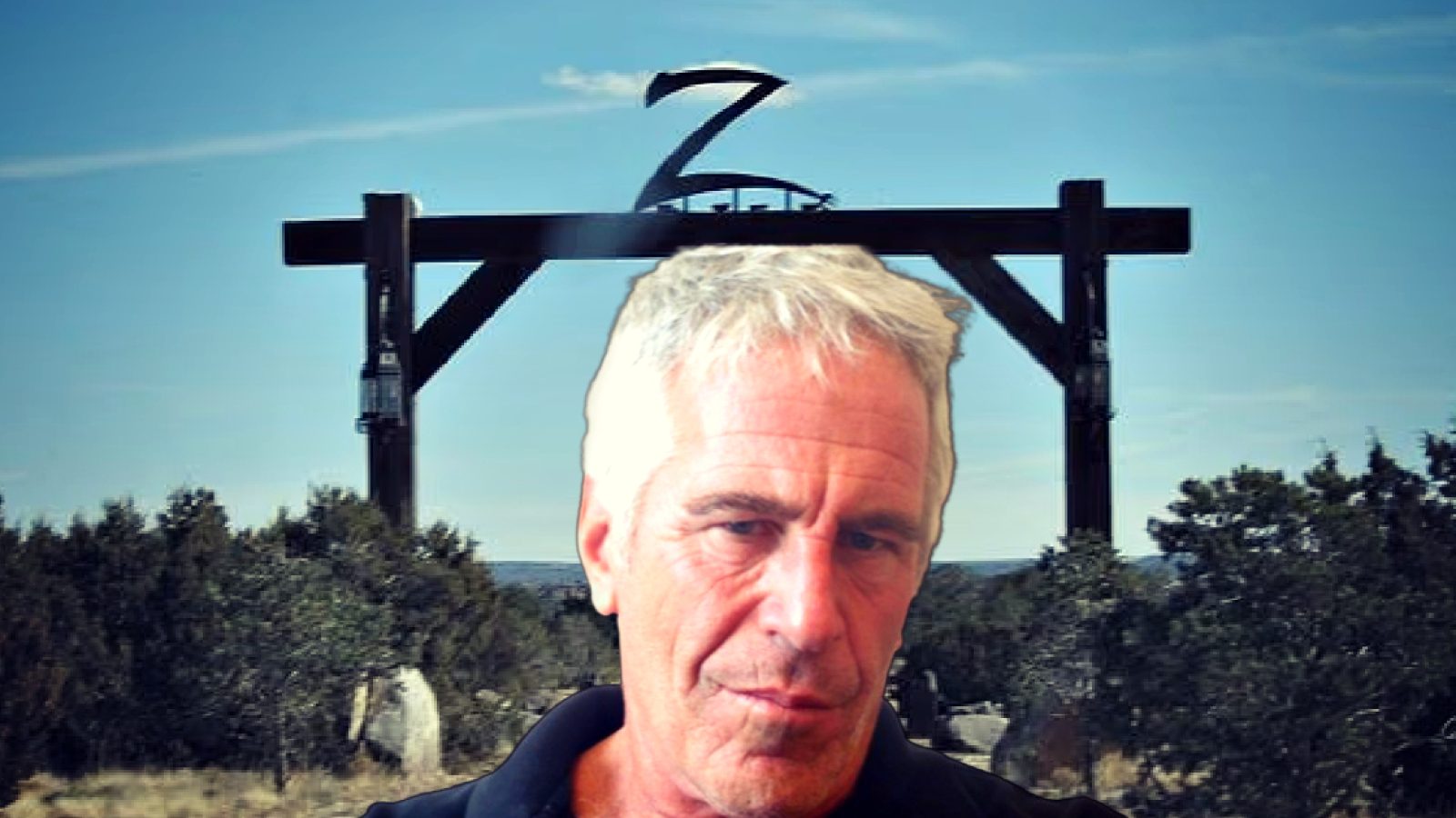 Portrait of a man in front of a large wooden structure against a blue sky, surrounded by trees in a rural setting.