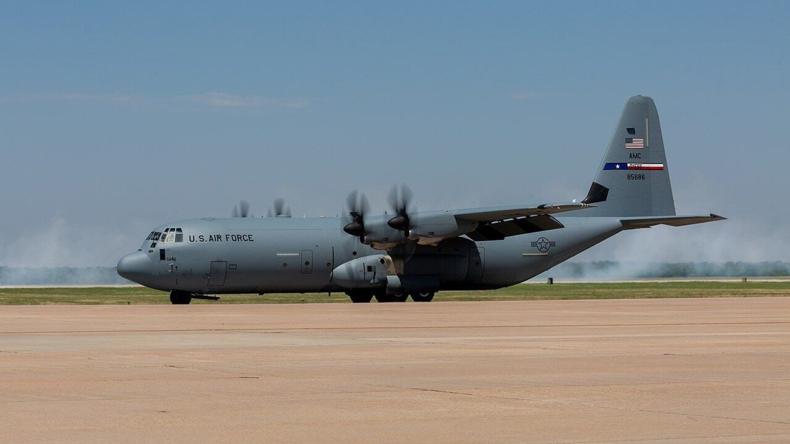 U.S. Air Force C-130 Hercules aircraft on the runway, showcasing its military design and capabilities during a clear day.