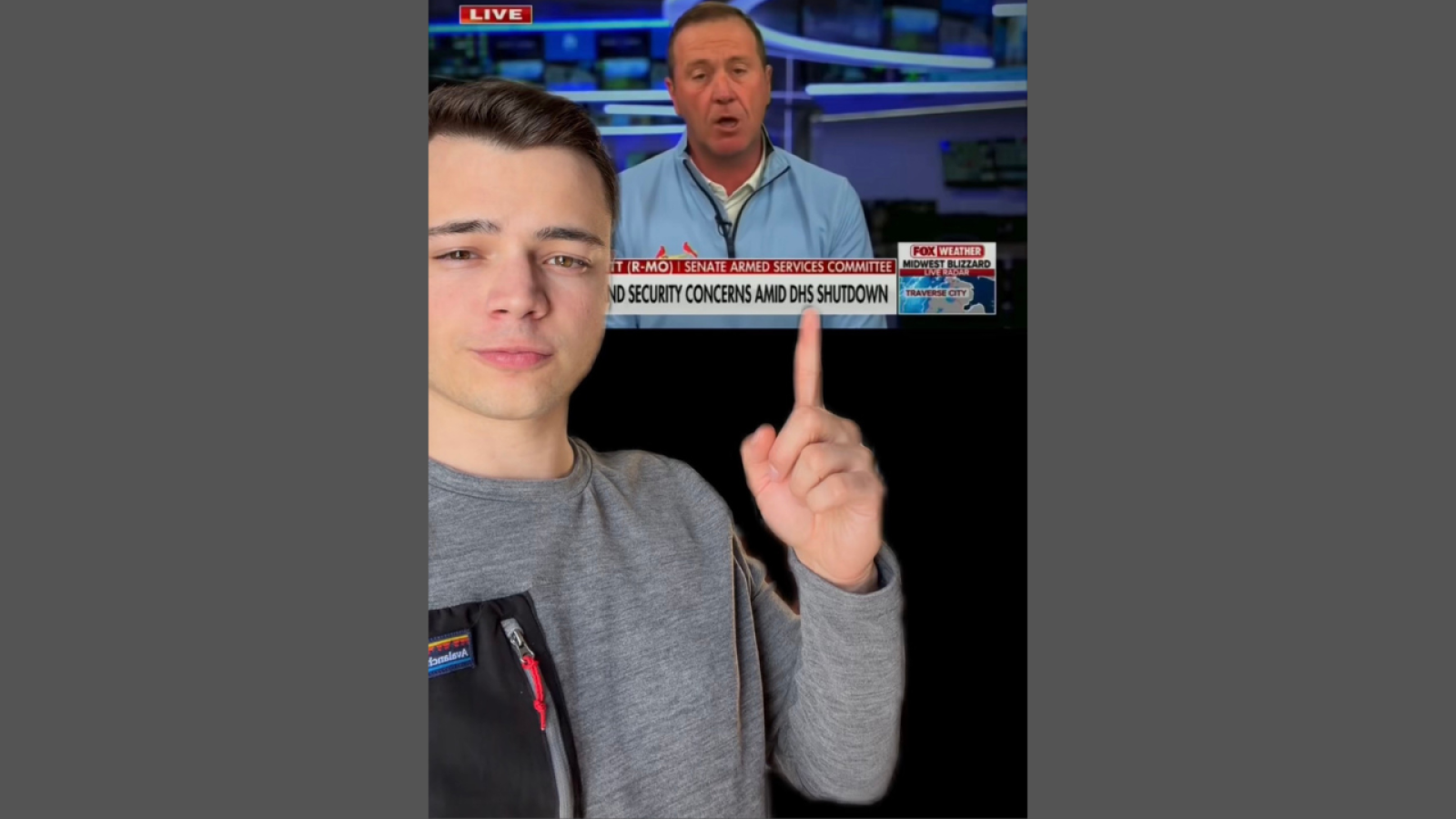 Young man pointing at a news broadcast discussing security concerns amid a DHS shutdown, with a television studio backdrop.