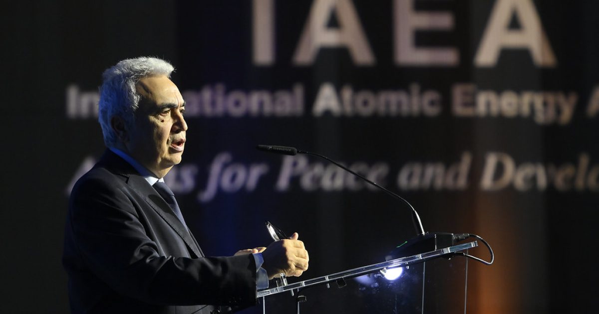 A speaker addresses an audience at the IAEA conference, highlighting the organization's commitment to peace and development in nuclear energy.