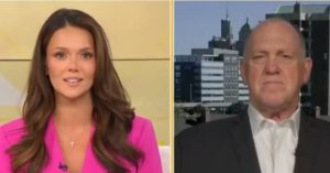News anchors discussing current events with a city skyline backdrop, showcasing a professional broadcast setting.