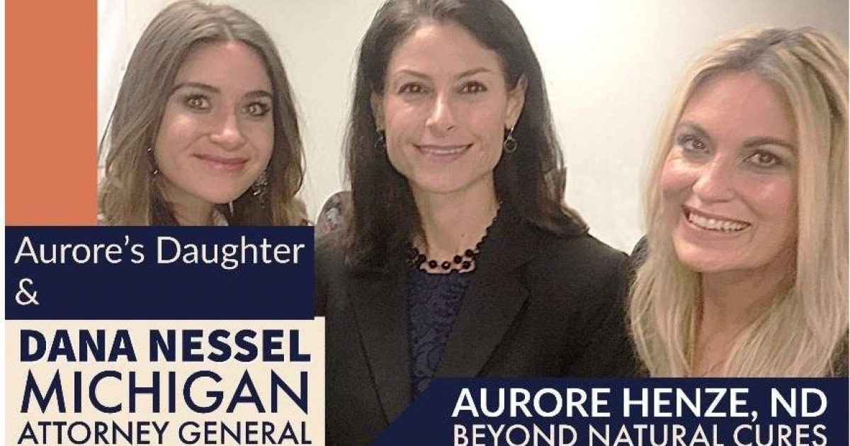 Aurore Henze, ND, poses with Michigan Attorney General Dana Nessel and Aurore's daughter at a public event promoting natural health and wellness.