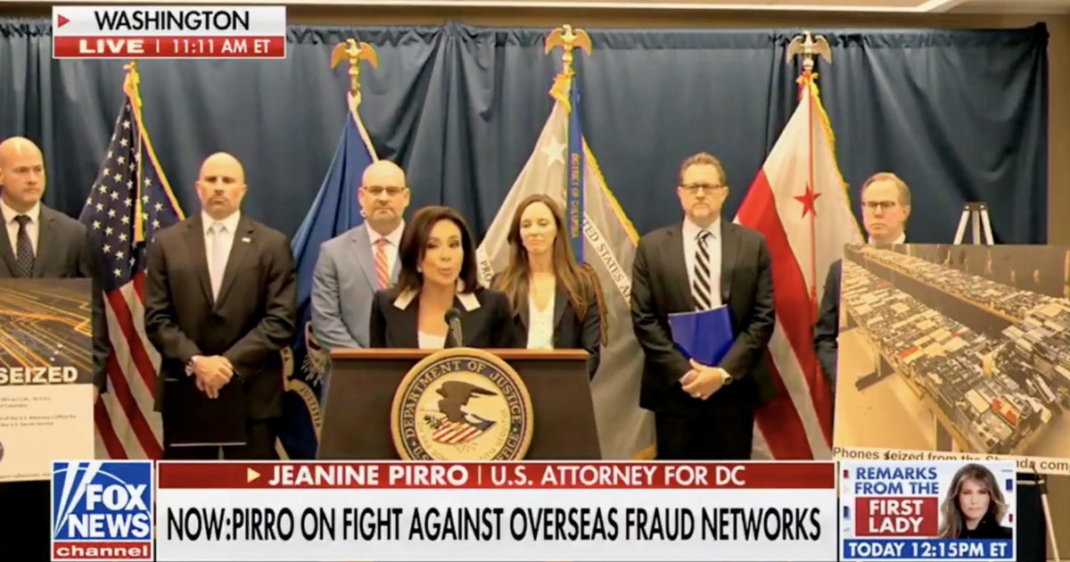 U.S. Attorney Jeanine Pirro speaks at a press conference in Washington, D.C., addressing the fight against overseas fraud networks, with officials and seized evidence displayed behind her.