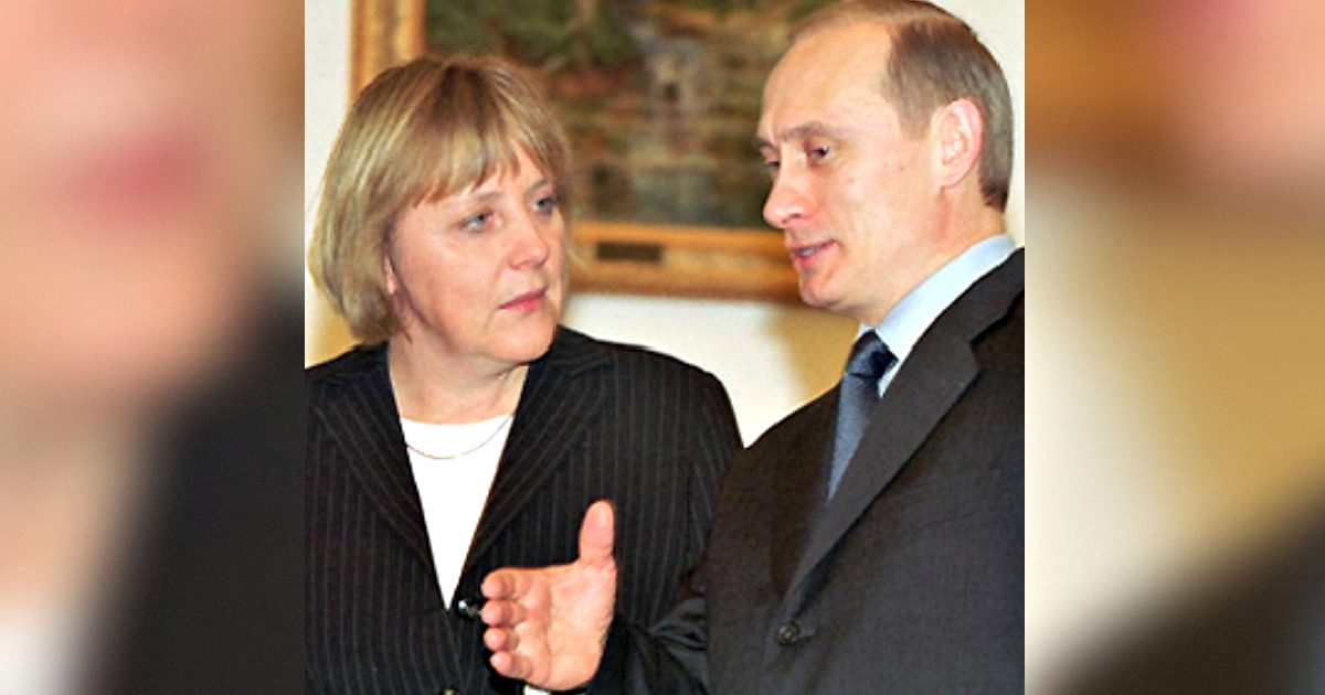 German Chancellor Angela Merkel and Russian President Vladimir Putin engage in a discussion during a formal meeting, showcasing diplomatic relations between Germany and Russia.