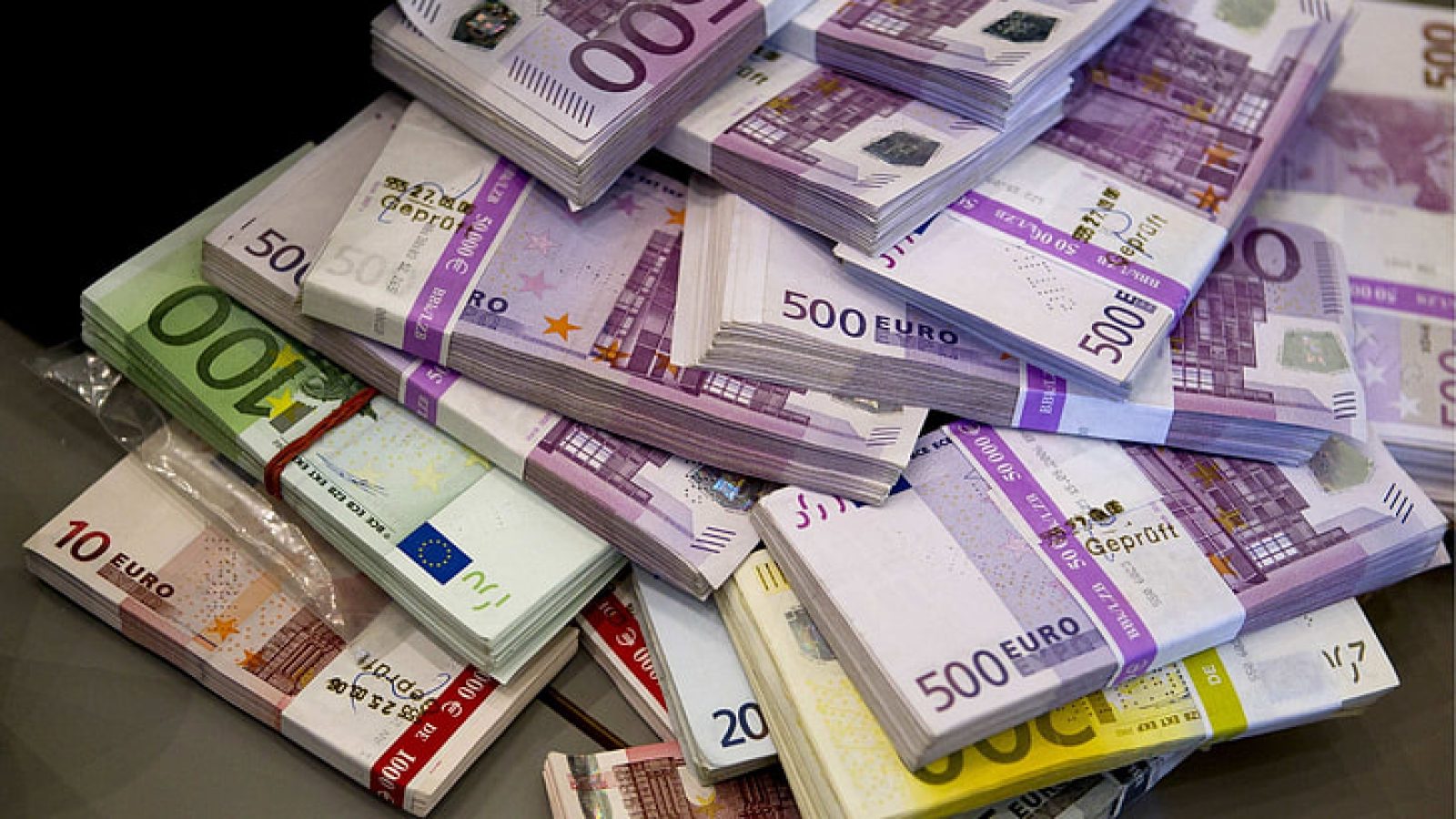 Stack of various Euro banknotes including 500, 100, and 10 Euro notes, illustrating significant currency value.