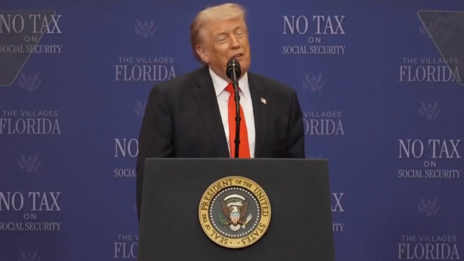 Donald Trump speaking at a podium during a press conference in The Villages, Florida, discussing social security tax policies.