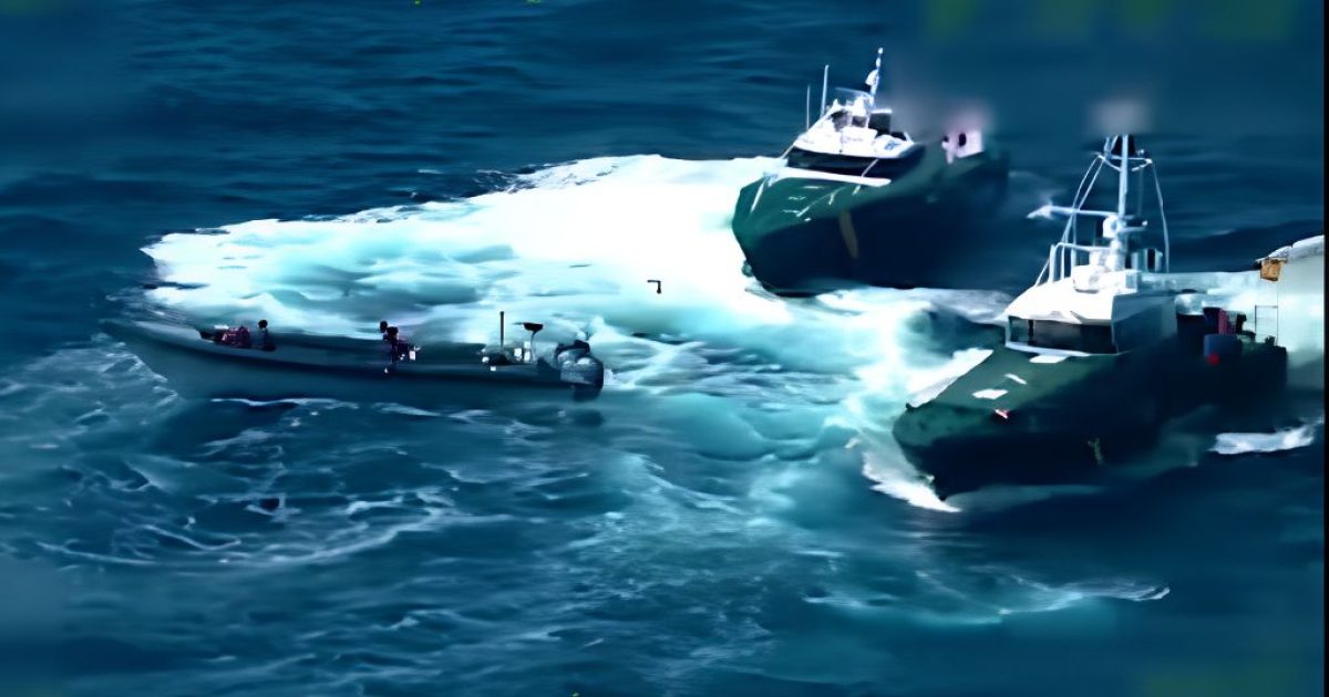 Two military boats maneuvering in ocean waters, creating a wake, with personnel visible on board.