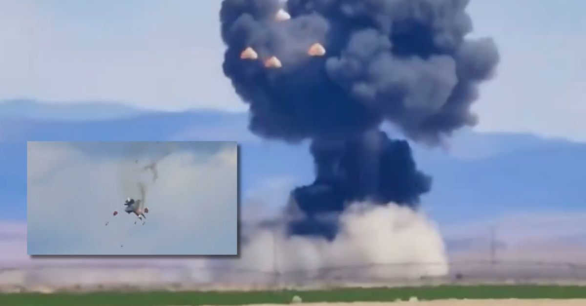 Explosion occurring in a desert landscape with a parachuting object visible in the foreground, showcasing a dramatic military test or accident scene.