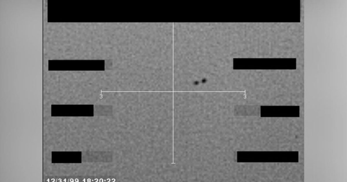 Black and white image showing a radar screen with two unidentified objects, timestamped December 31, 1999, highlighting potential UFO activity.