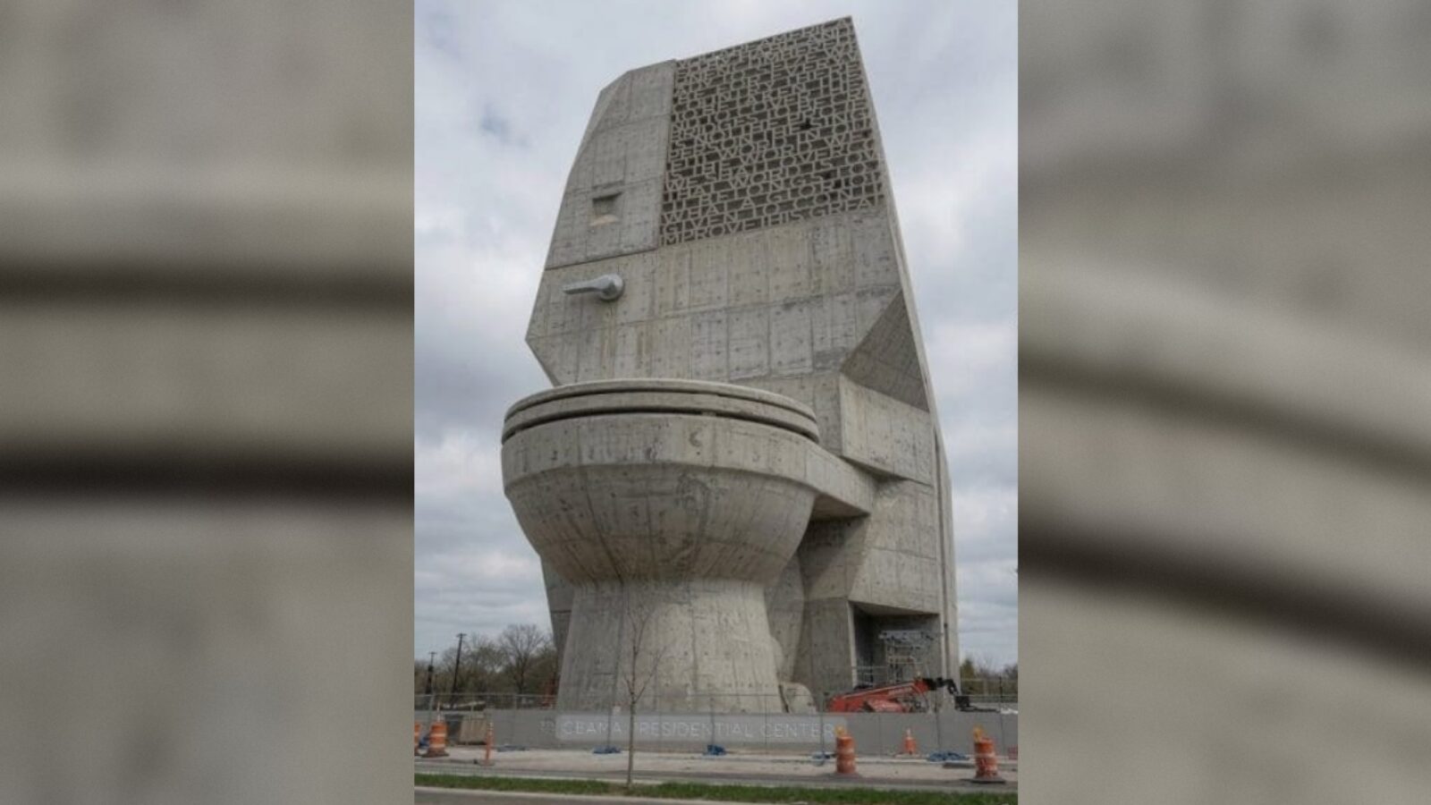 Unique architectural structure resembling a giant toilet, part of the design for a residential center, showcasing modern concrete artistry.
