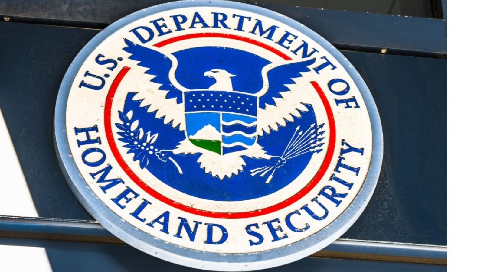 Seal of the U.S. Department of Homeland Security displayed on a building exterior, symbolizing national security and protective services.