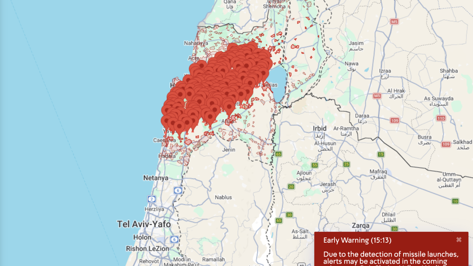 Map showing missile launch alerts in northern Israel, highlighting affected areas such as Galilee and Golan Heights with red markers for early warning notifications.