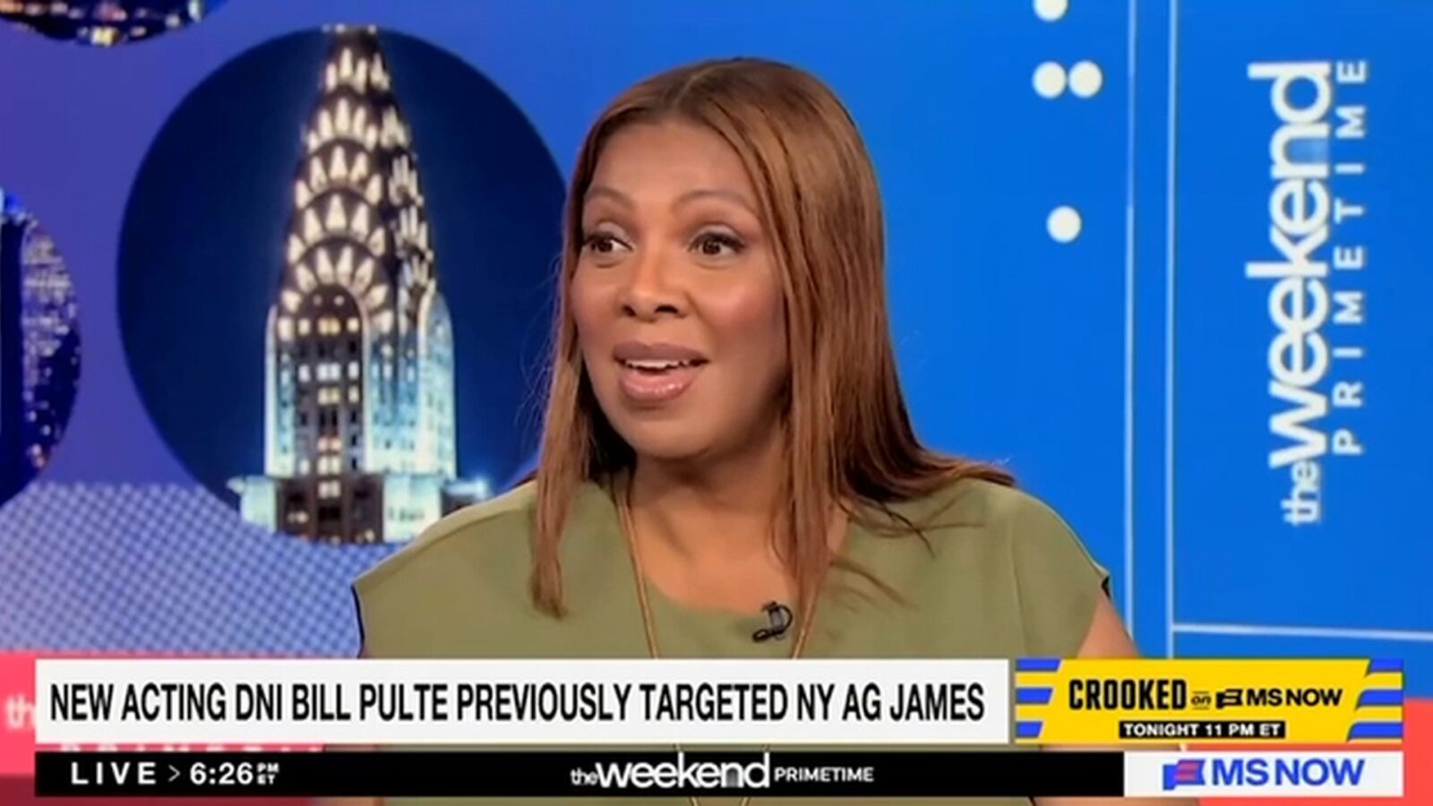 Woman speaking on a news program about the new acting DNI Bill Pulte and his previous actions targeting New York AG Letitia James, with the Chrysler Building in the background.