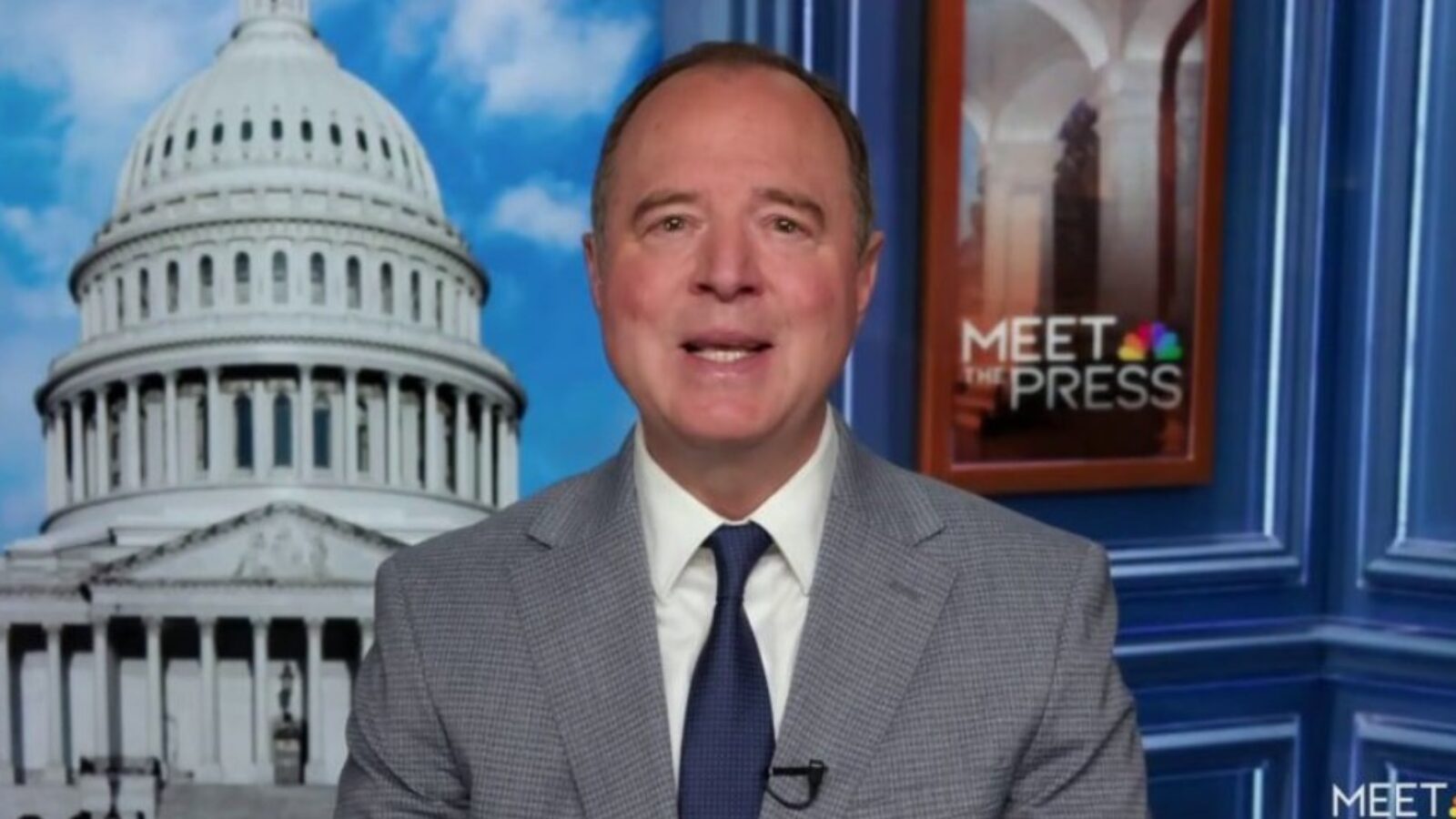 Political commentator discussing current events on a news program set, featuring the U.S. Capitol in the background.