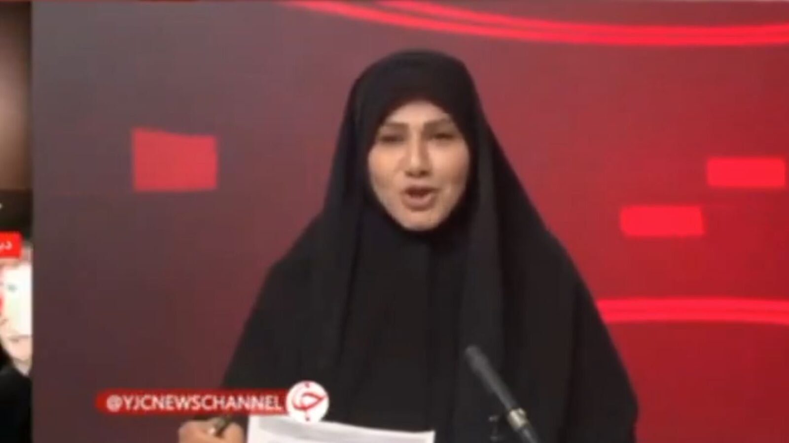 Female news anchor presenting a segment on YJC News Channel, wearing a black hijab against a vibrant red background.
