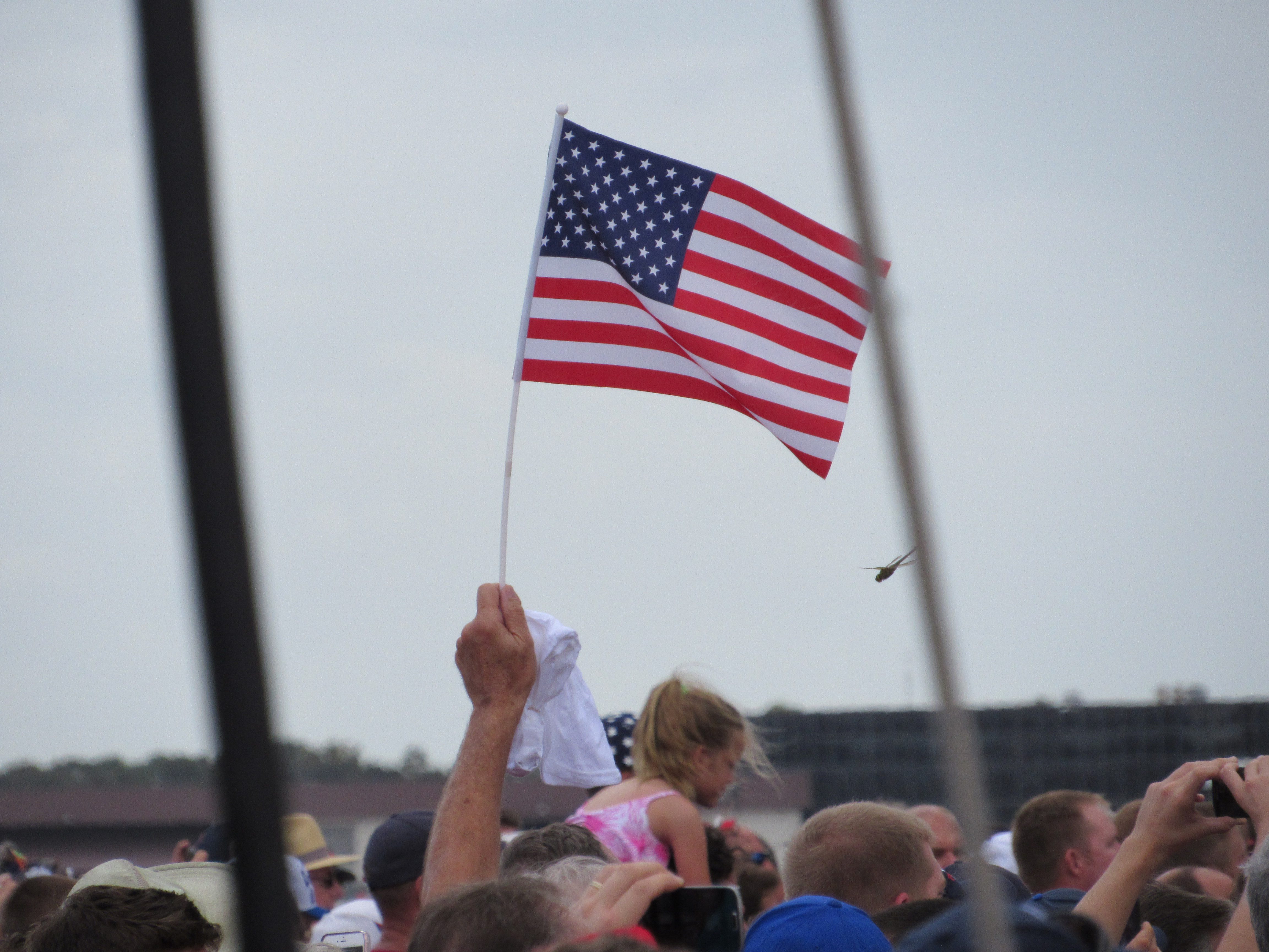 Trump supporter waves American flag at Trump Lakeland, FL rally Oct 12, 2016