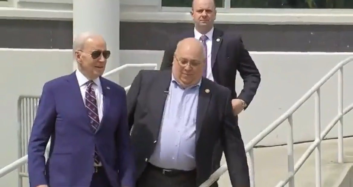 HOT MIC Catches Handler Telling Biden How to Walk and Where to Stand: “Yes… Down the Ramp…Your Mark is Gonna be the Blue One” (VIDEO)