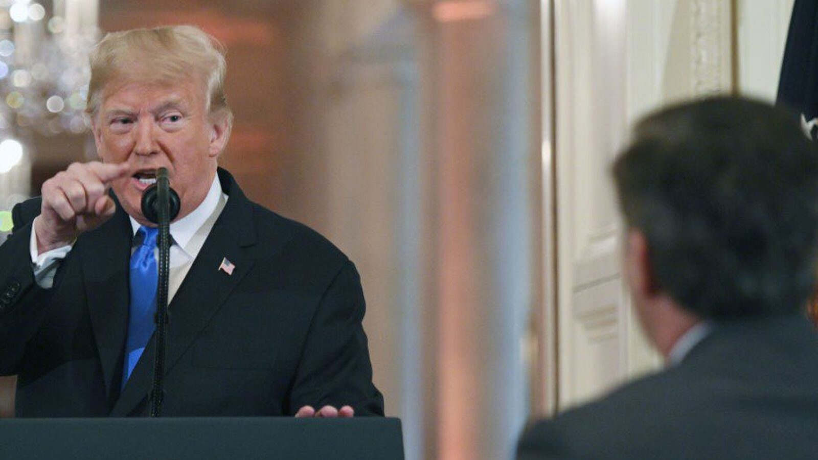 TOPSHOT - US President Donald Trump points to journalist Jim Acosta from CNN during a post-election press conference in the East Room of the White House in Washington, DC on November 7, 2018. (Photo by Jim WATSON / AFP) (Photo credit should read