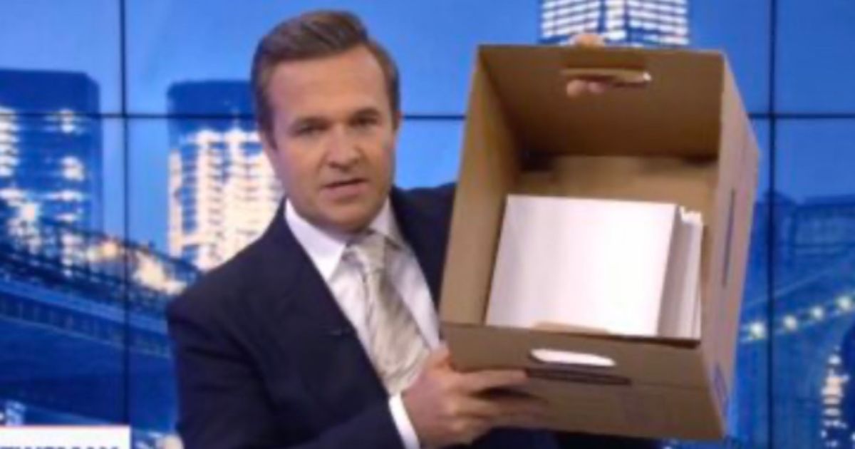 Newsman host Greg Kelly holds up a box to show the number of documents former President Donald allegedly did not declassify.